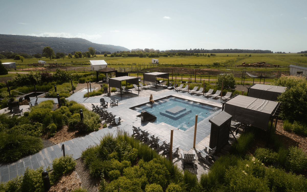 An aerial view of a woman relaxing in the pool at Le Germain Charlevoix Hotel & Spa.