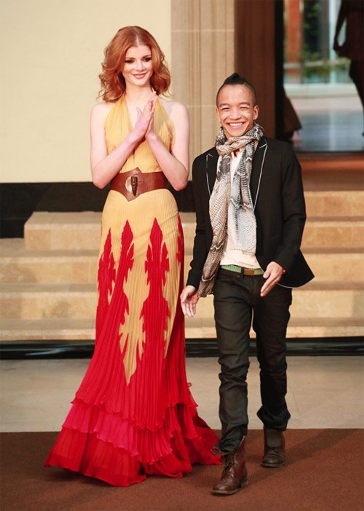 A model walks with designer Sunny Fong at the Vawk Spring 2010 show. Photography by Angela Y. Martin