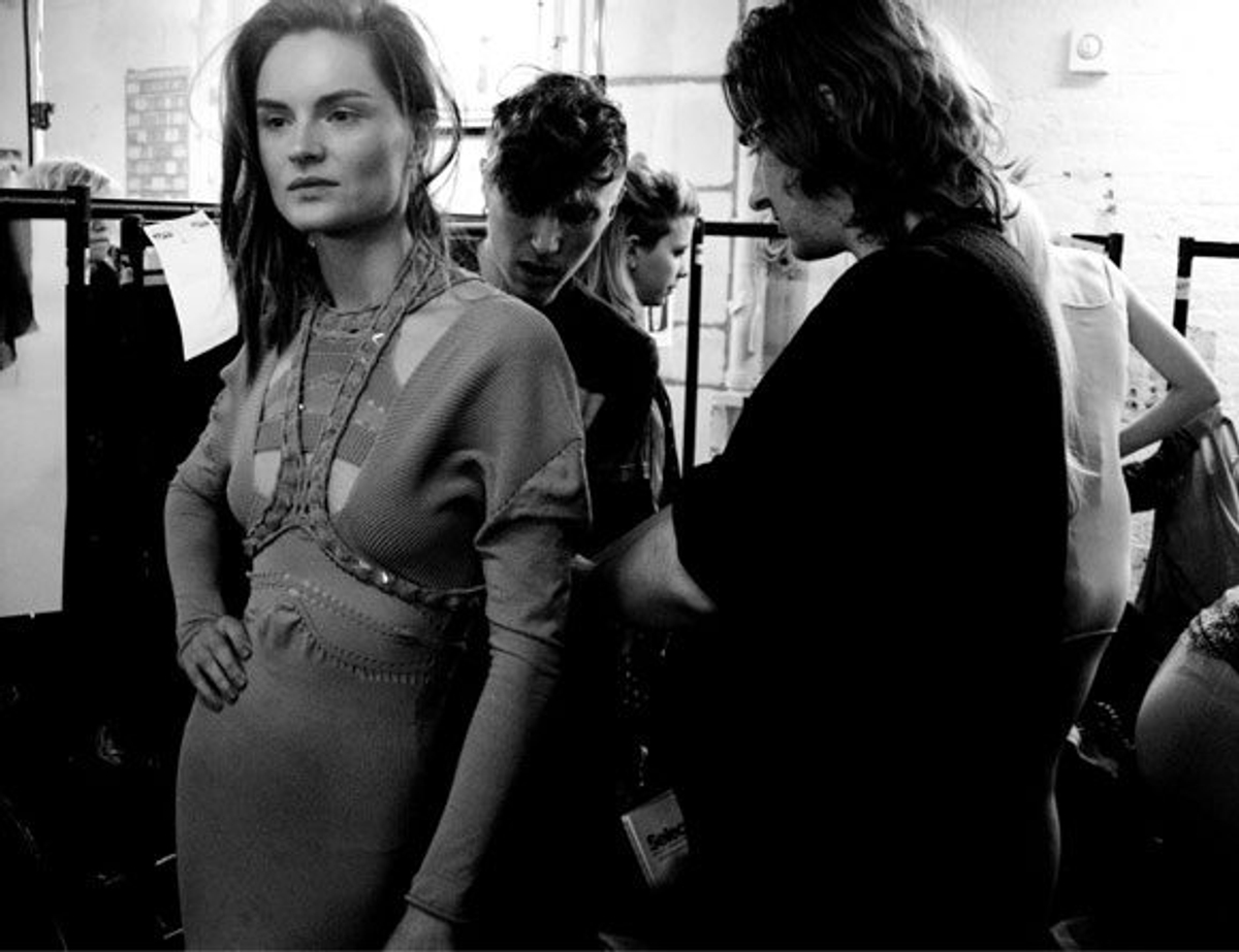 Mark Fast puts the finishing touches on a look worn by model Anouck Lepere. Photography by Fiona Garden