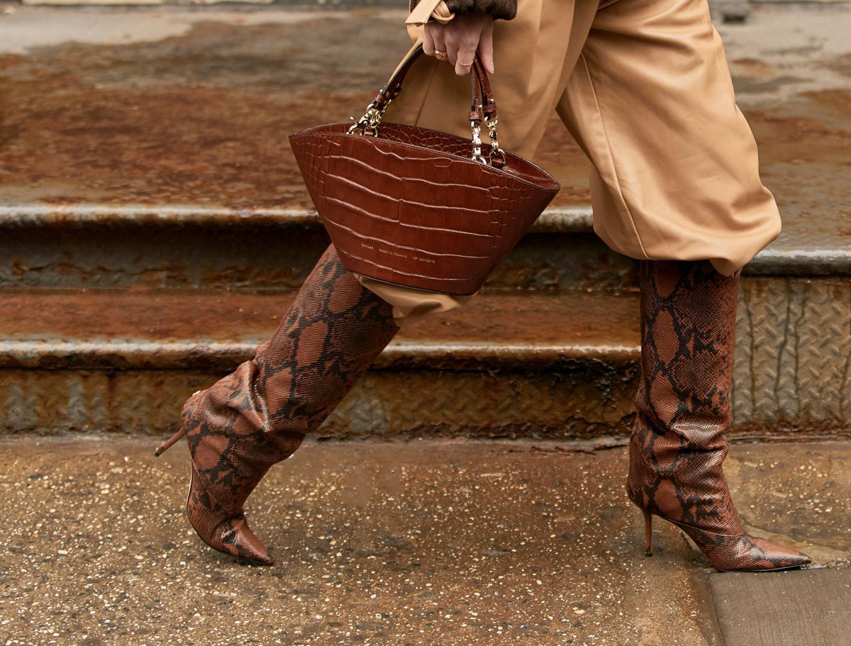 pants tucked into boots streetstyle closeup brown snakeskin