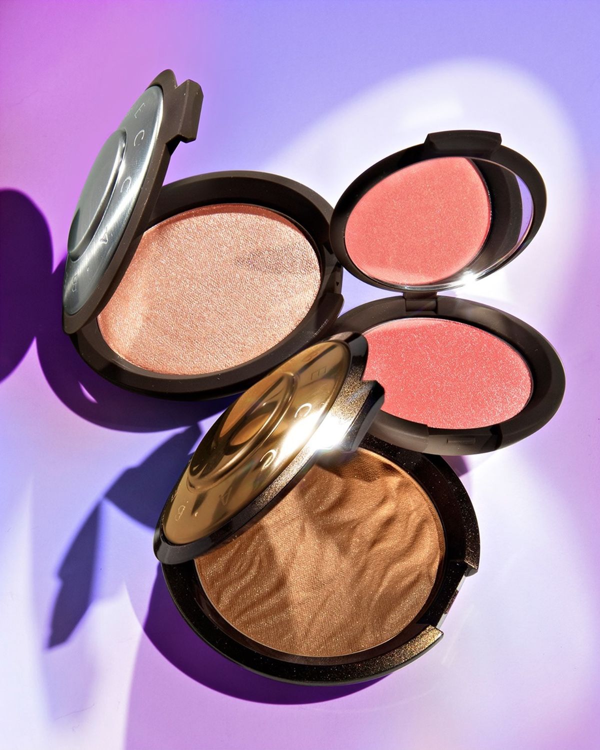 An aerial shot of three BECCA Cosmetics products to accompany a story about Becca Cosmetics closing