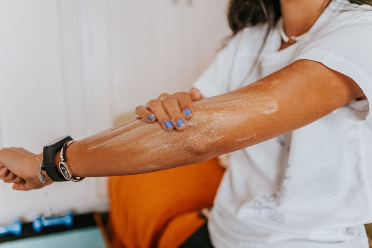 Woman applying sunscreen