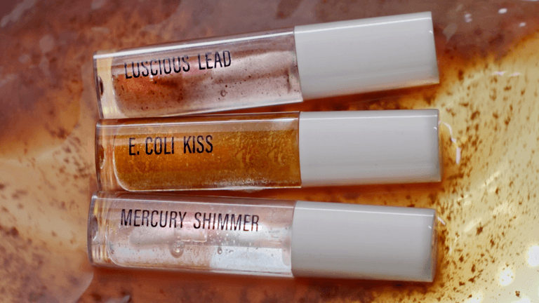 Three lipglosses with the titles Luscious Lead, E.Coli Kiss and Mercury Shimmer.
