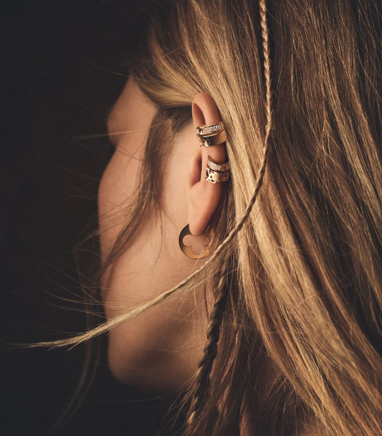 model wearing an earring stack from Louis Vuitton Empreinte collection