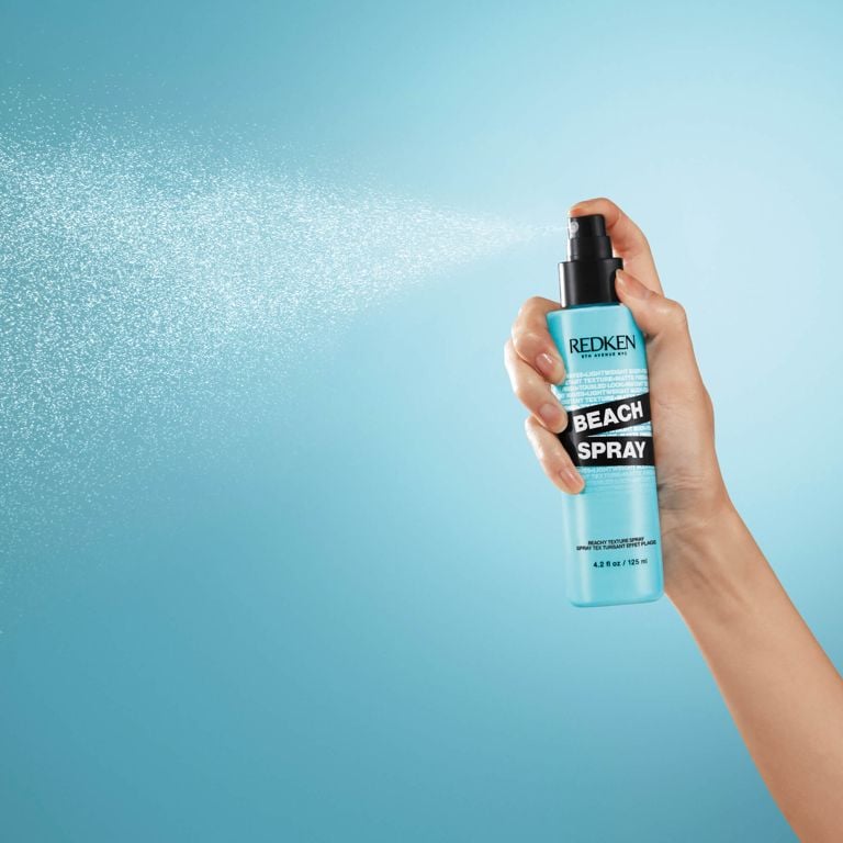 Redken Beach Spray being spritzed by hand