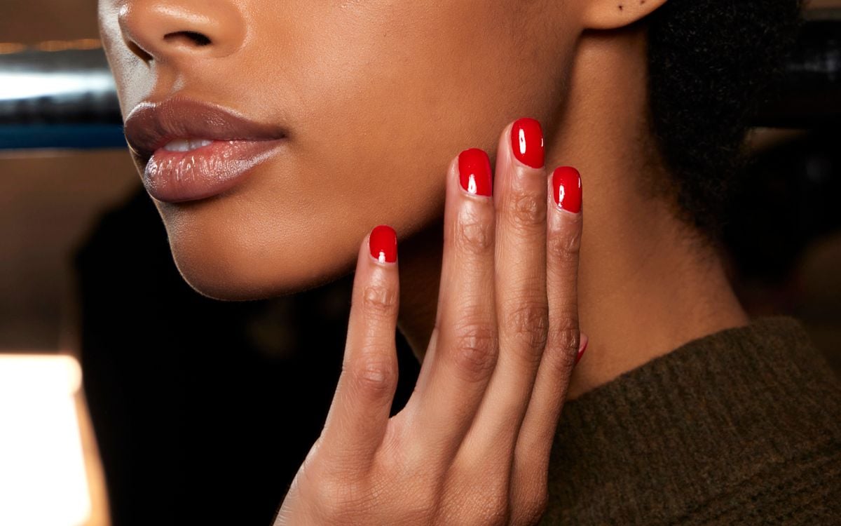 a photo of a model with red nails