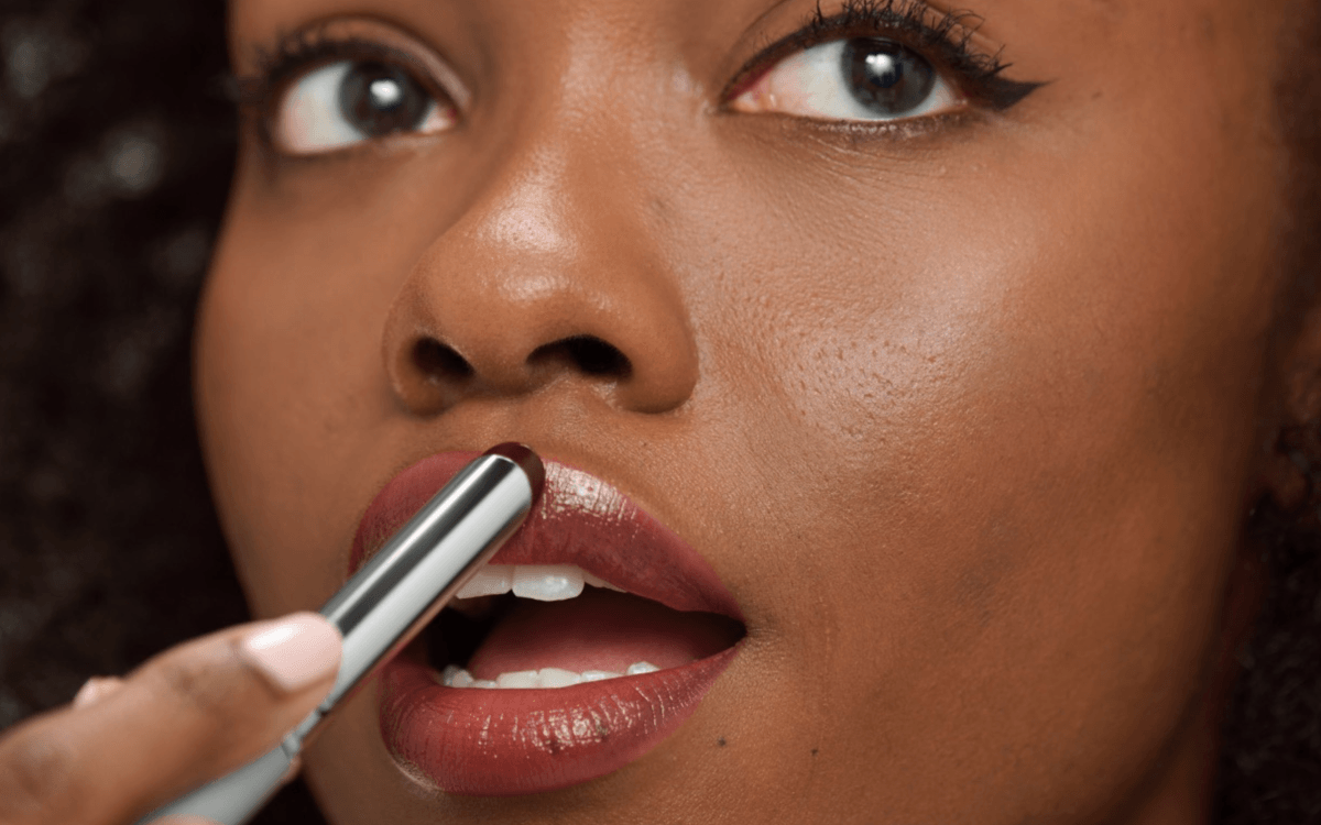 Woman applying Clinique Black Honey Lipstick