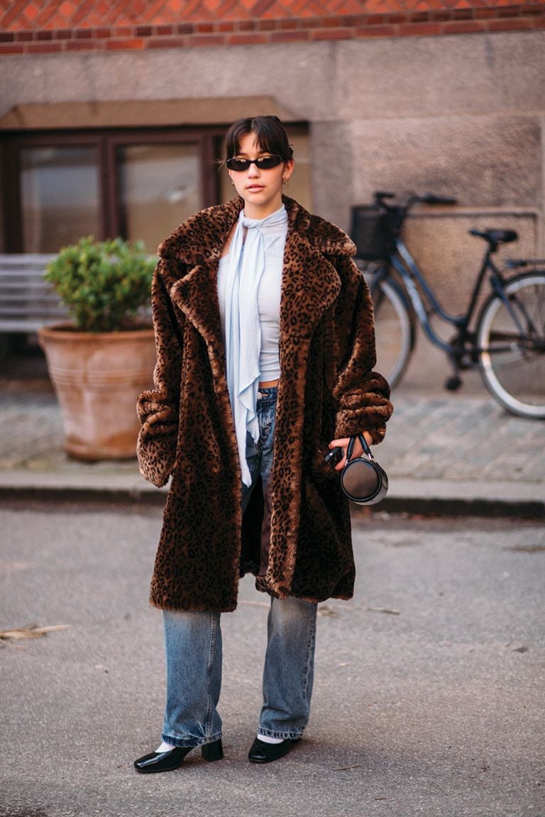 Woman wearing brown faux-fur jacket, latte dressing