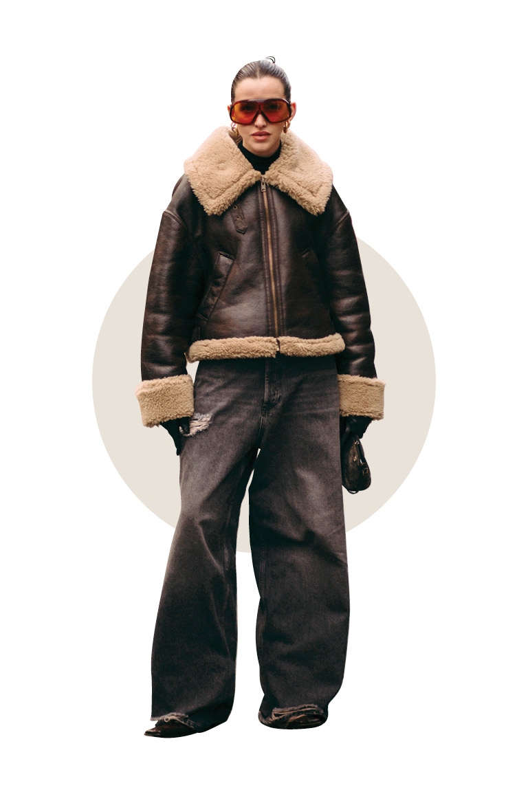 Woman wearing brown bomber jacket, latte dressing