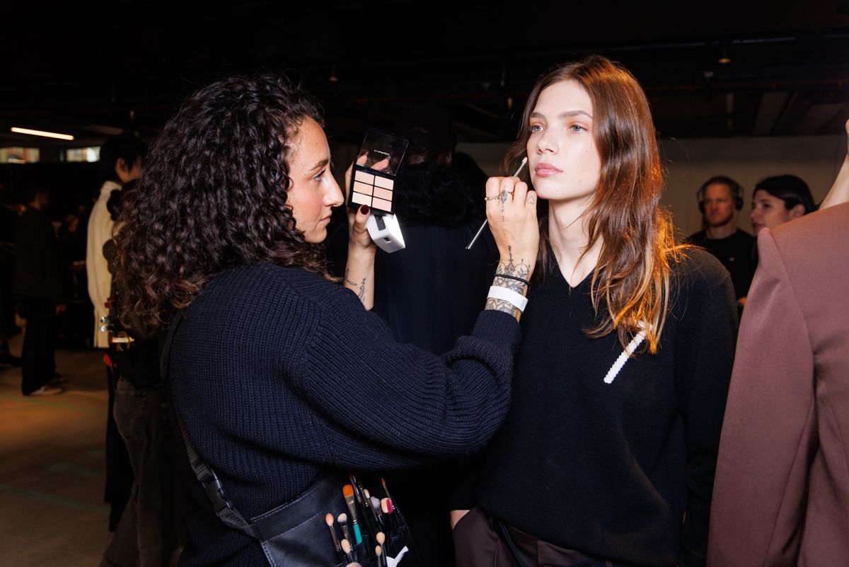 Why foundation looks patchy: Makeup artist applies a model's makeup backstage