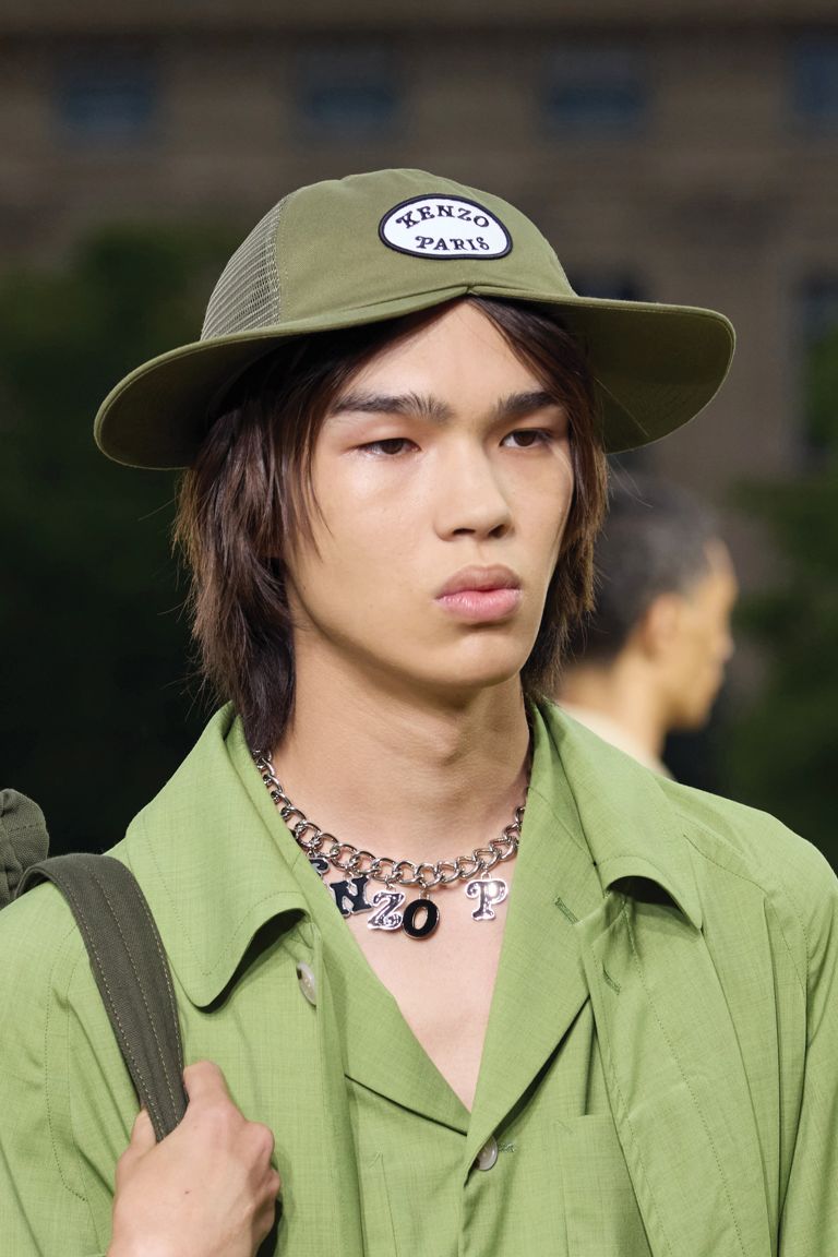 A runway models wears a green hat