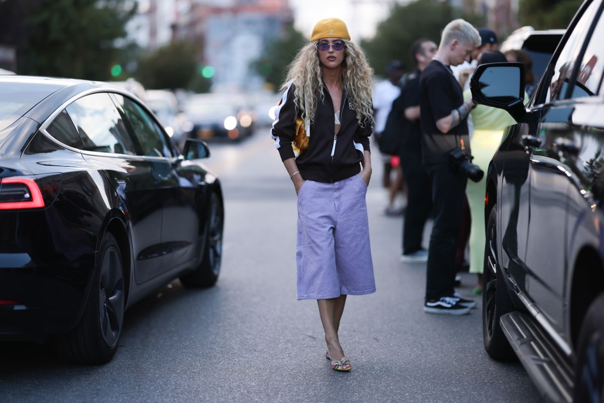 street style image of a woman wearing purple denim culottes