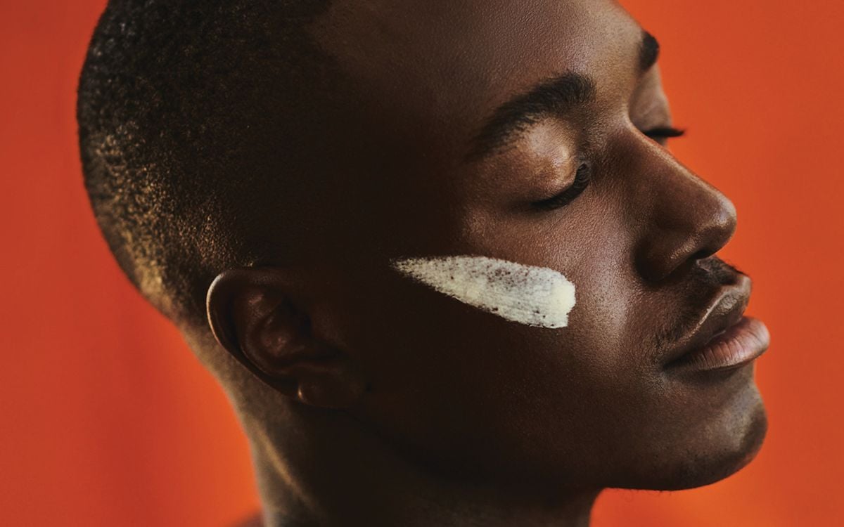 Skincare smothered across the cheek of subject.