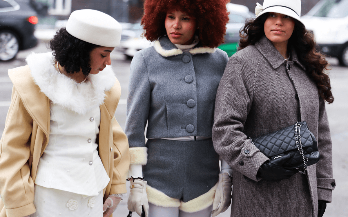 With purses in hand and buttoned up winter coats, three women walk the streets of Copenhagen's Fashion Week.