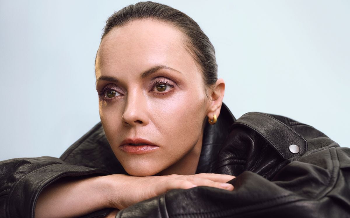 A model with minimal makeup stares to the left of the camera