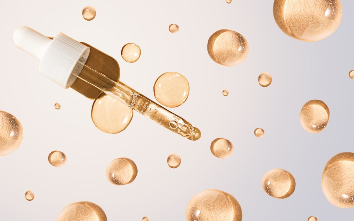 A dropper and serum dots against a white backdrop, chemical peels