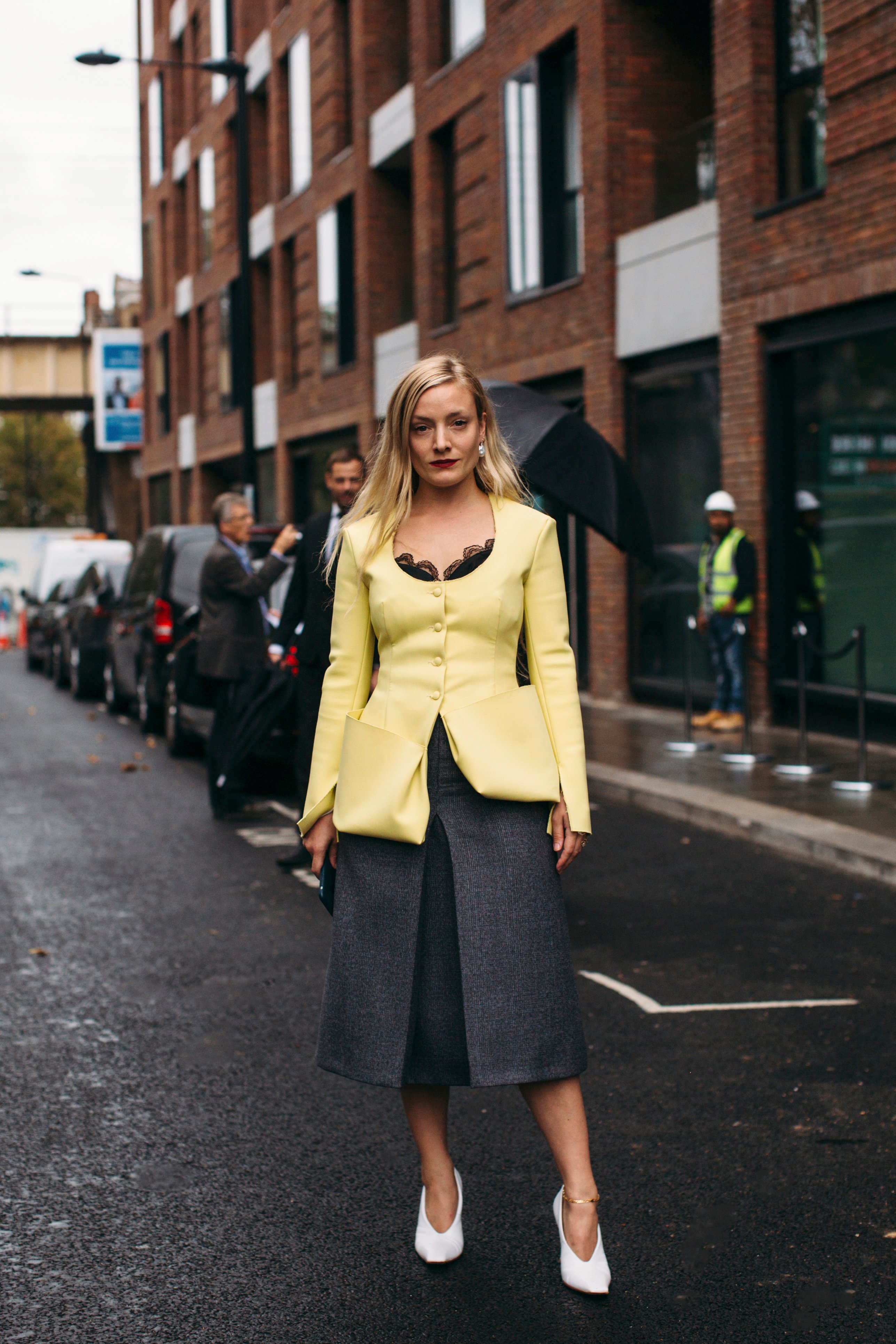 Woman in yellow blazer and grey pants