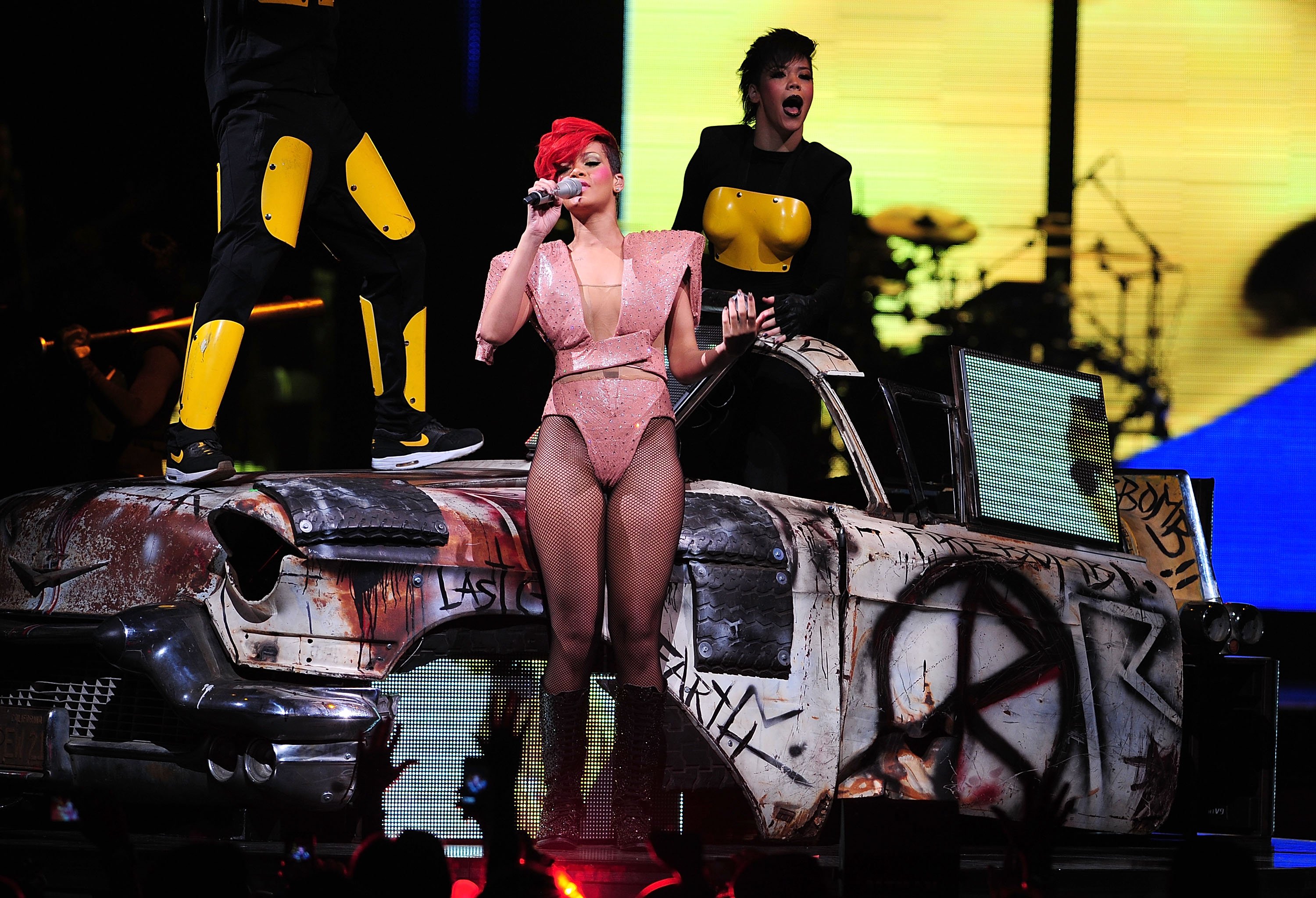 Pop girls in bodysuits: Rihanna performs in a structured pink bodysuit