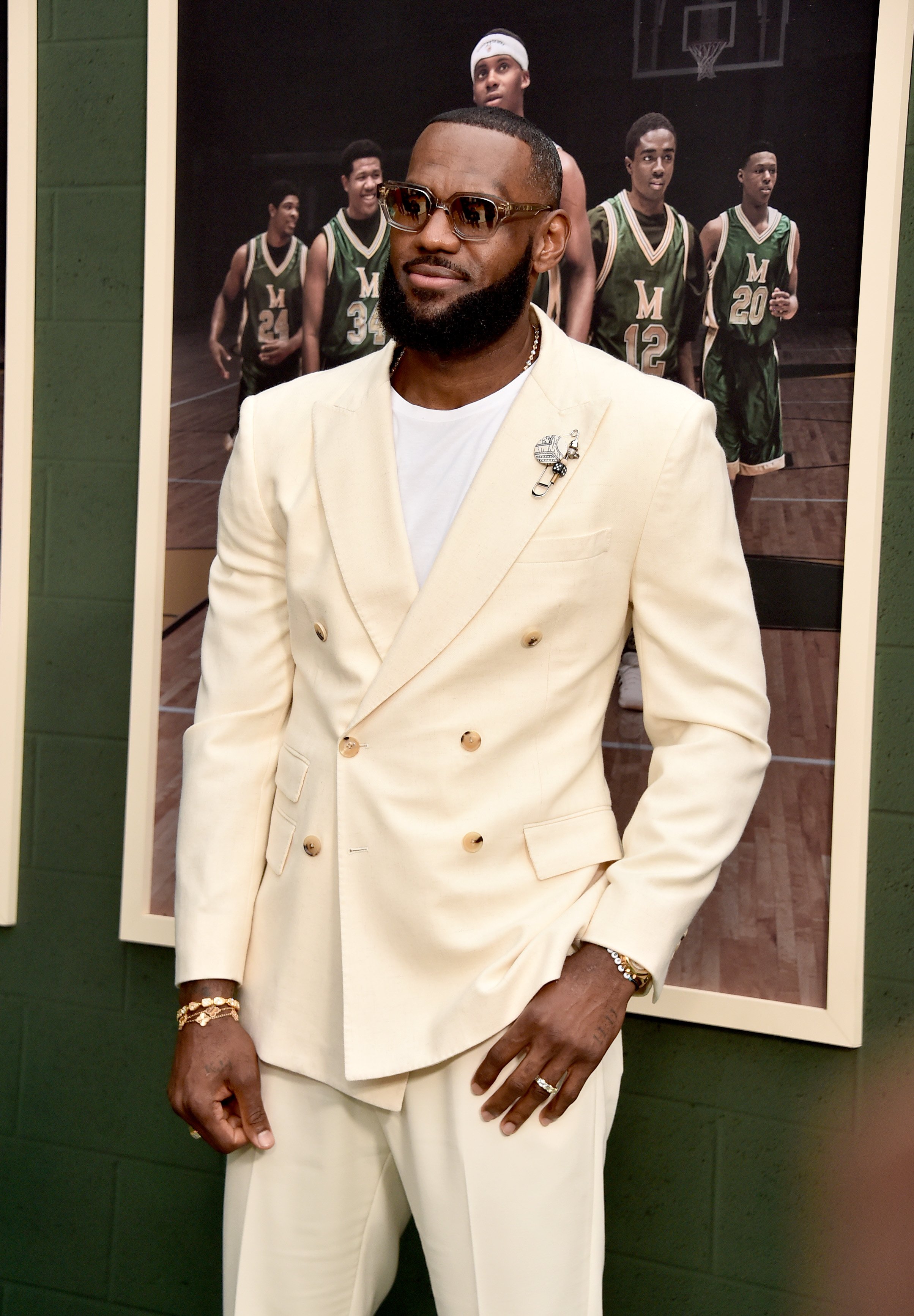 LeBron James wearing an all white suit and several sparkly bracelets 